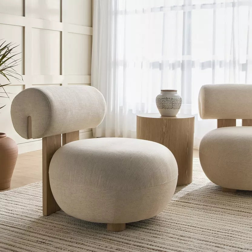 Modern beige armchair in a room with light decor