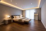 wide angel for bedroom in modern style for king-size bed with brown HDF at floors with 6 round small spot lights and cove warm light on ceiling